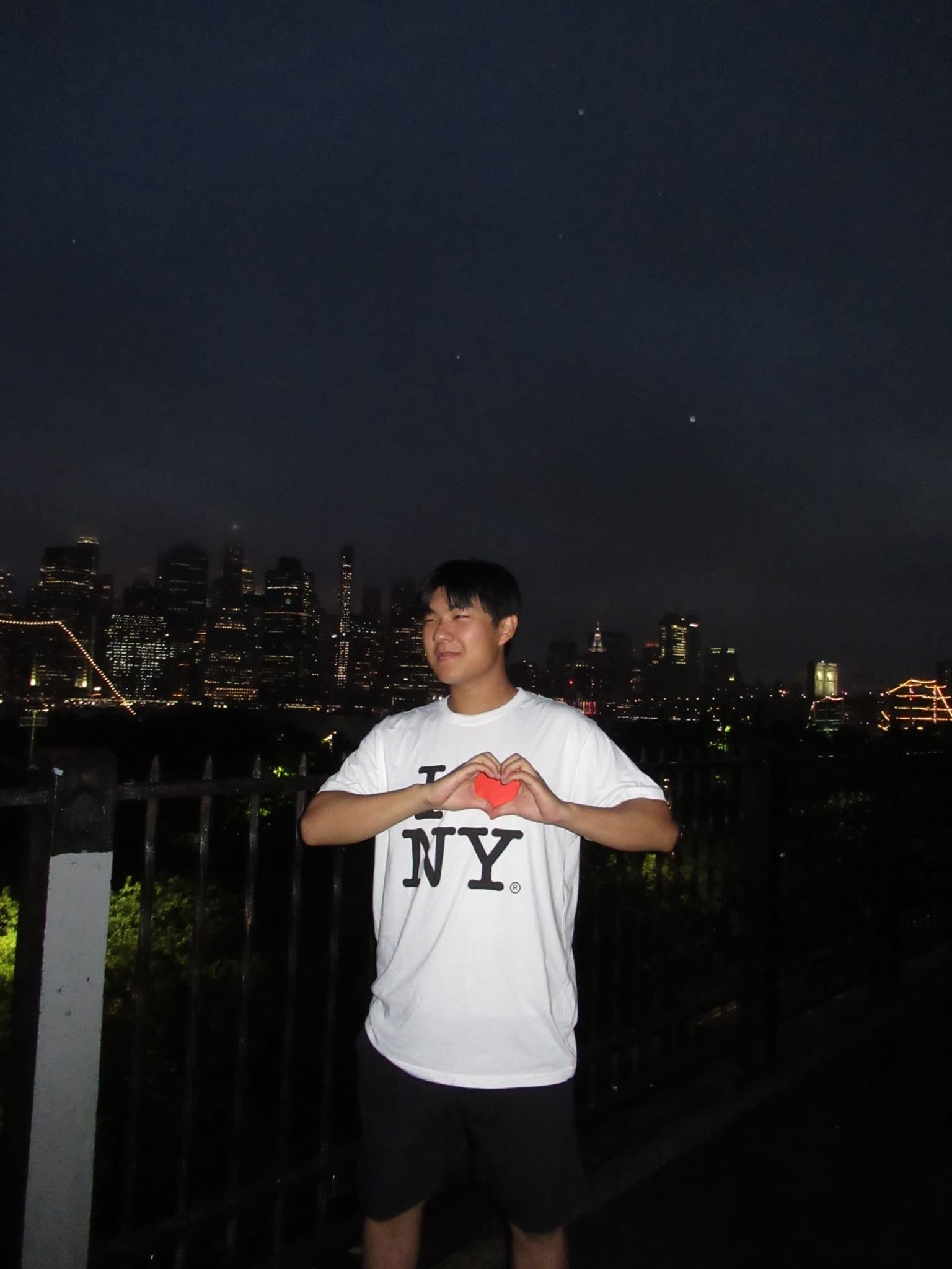 Wearing an I Love NY shirt with the skyline behind