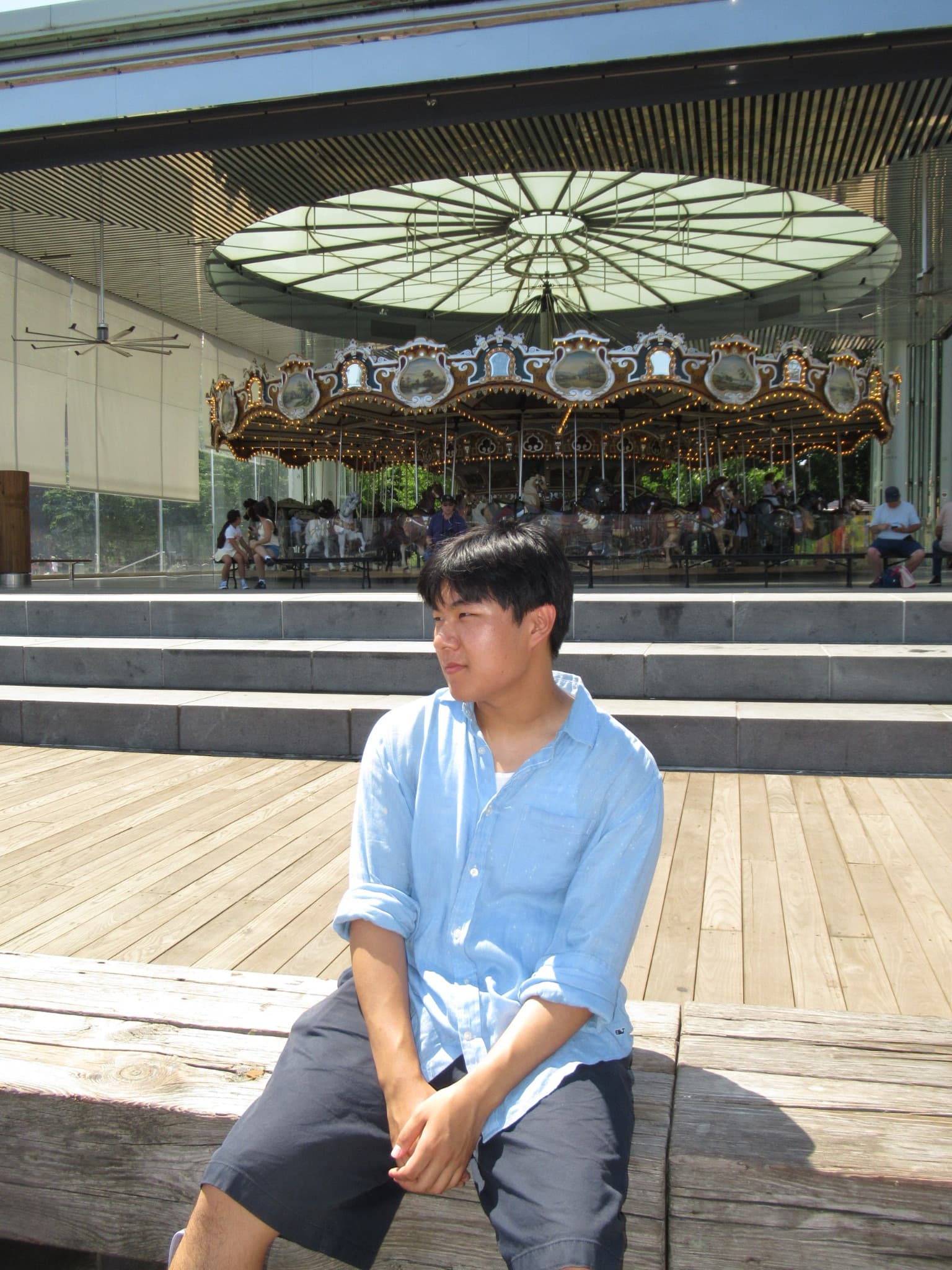 Sitting in front of the carousel at Pier 17