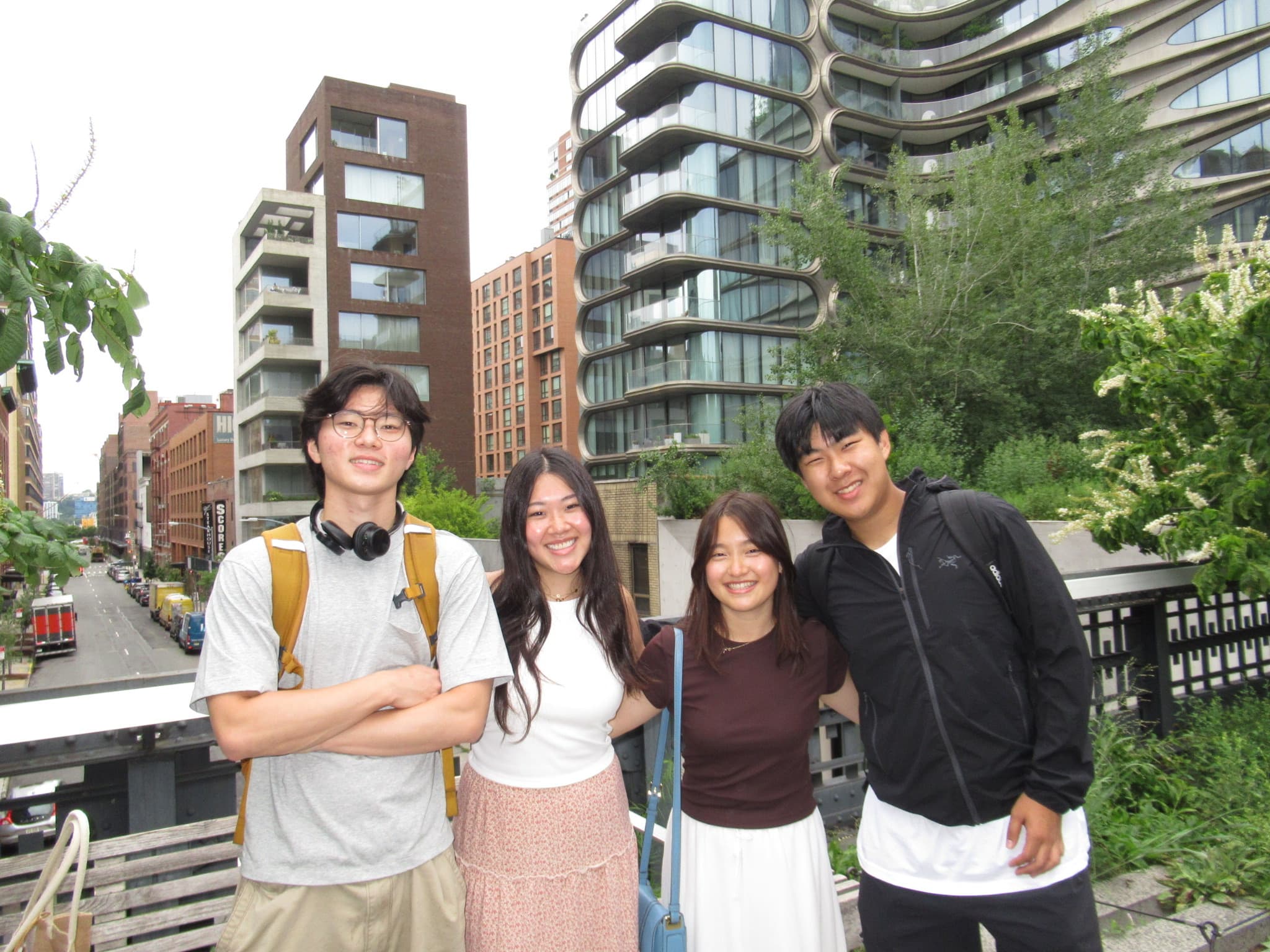 With friends in front of a row of high-rises