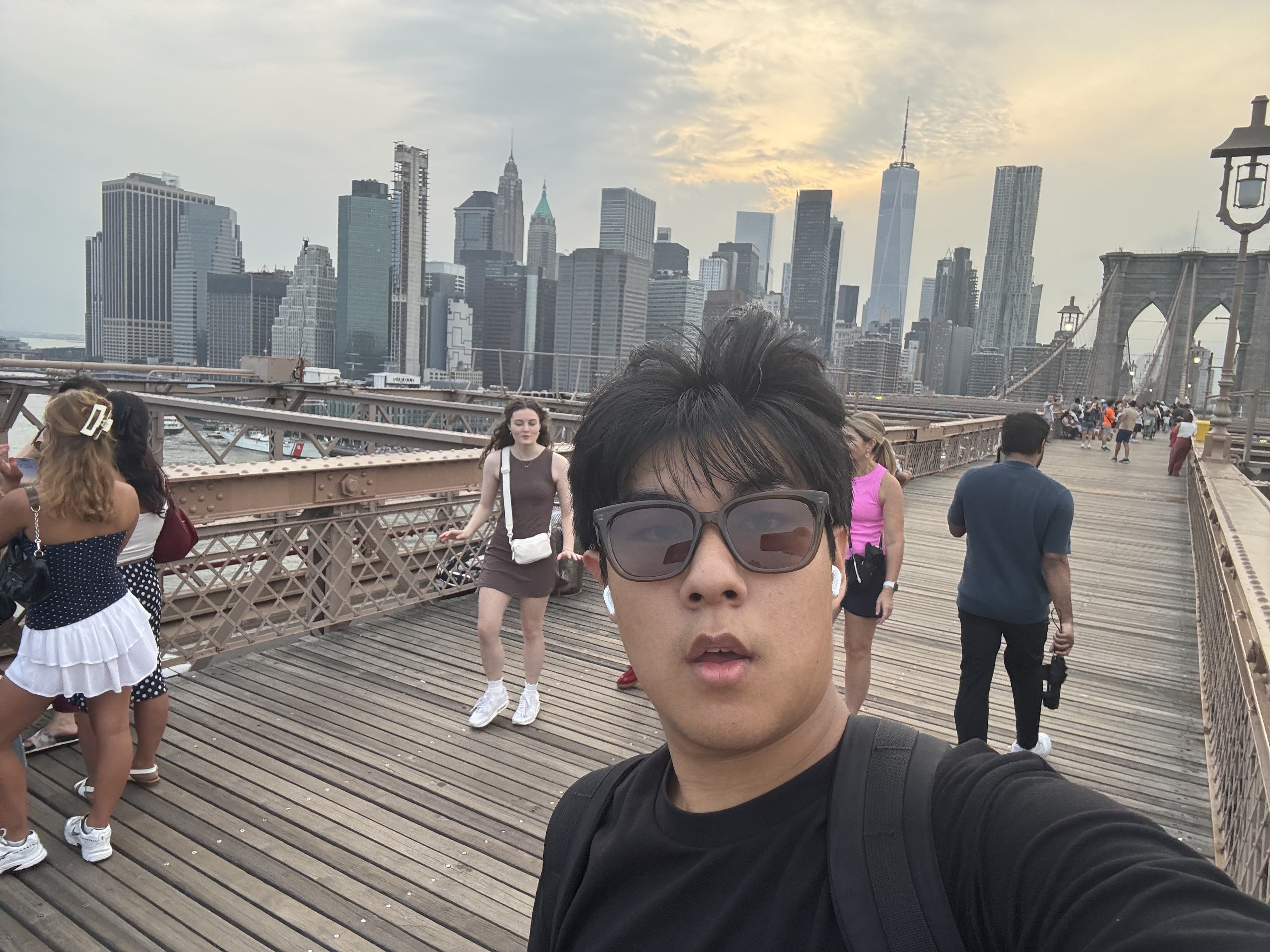On the Brooklyn Bridge with the Manhattan skyline behind